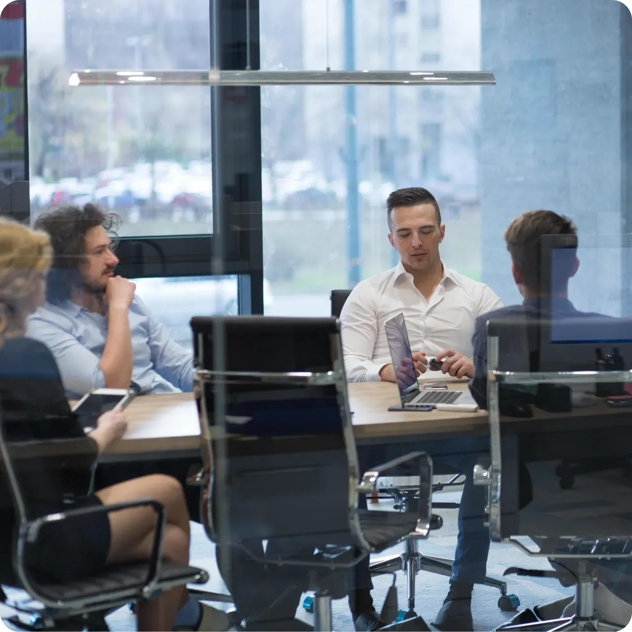 Engineers discussing a project around a meeting-room table